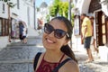 Close up of stylish young woman with sunglasses smiling in italian scenery background. Beauty woman with white perfect smile looki Royalty Free Stock Photo