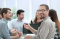 Close up.successful businessman sitting at his Desk with a business team Royalty Free Stock Photo