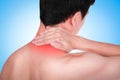 Close up suffering male pain in neck on blue background. Royalty Free Stock Photo