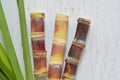 Close up sugar cane on rustic wood table.Brown sugar and cane on wood background.Cane top view.Cane .