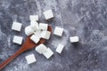 Close up of sugar cube on wooden spoon. Royalty Free Stock Photo