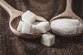 Close up the sugar cubes and cane in wooden spoon on table ,ret Royalty Free Stock Photo