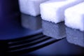 Close up of sugar cubes with folk shadow Royalty Free Stock Photo