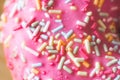 Sugar sprinkled pink donut glace, close up picture Royalty Free Stock Photo