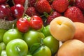 Close up summer fruits background, green plum, red cherry, strawberry, apricot Royalty Free Stock Photo