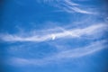 Close-up of the summer sky. A lot of soft clouds blocked the moon, which is faintly visible in the light blue sky Royalty Free Stock Photo