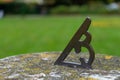 a close up of a sun dial on a stone stand in a garden Royalty Free Stock Photo