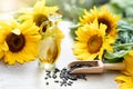 Close-up of sunflower oil with seeds on wooden background Royalty Free Stock Photo