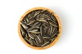 Close up of sunflower seeds isolated in wooden bowl against top view on white background and clipping path Royalty Free Stock Photo