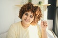 Close up sunny portrait happy smiling curvy plus size African black woman afro hair with make up posing in beige t-shirt