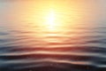 Close-up of the sunset at the sea. Calm surface of dark blue water and yellow-red reflex from the sun, outdoors. Royalty Free Stock Photo