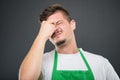 Close-up of supermarket employer standing acting tired Royalty Free Stock Photo