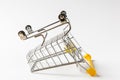 Close up of supermarket grocery inverted push cart for shopping with black wheels and yellow plastic elements on handle Royalty Free Stock Photo