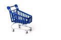 Close up of supermarket grocery push cart for shopping with black wheels and plastic elements on handle isolated on Royalty Free Stock Photo