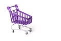 Close up of supermarket grocery push cart for shopping with black wheels and plastic elements on handle isolated on Royalty Free Stock Photo