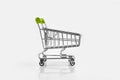Close up of supermarket grocery push cart for shopping with black wheels on white background. Concept of shopping. Royalty Free Stock Photo