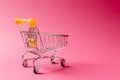 Close up of supermarket grocery push cart for shopping with black wheels and yellow plastic elements on handle isolated Royalty Free Stock Photo