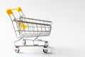 Close up of supermarket grocery push cart for shopping with black wheels and yellow plastic elements on handle isolated Royalty Free Stock Photo
