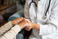 Close up of supportive female caregiver hold hand of mature grandmother visit patient at home, caring woman doctor support old Royalty Free Stock Photo