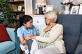 Close up of supportive female caregiver hold hand of mature grandmother visit patient at home, caring woman doctor support old Royalty Free Stock Photo