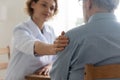 Supportive female doctor comfort elderly patient in hospital Royalty Free Stock Photo