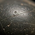 Close-up of a surface with a dark, rough matte texture and small indentations. The Royalty Free Stock Photo