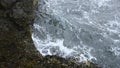 Close-up of surge of waves on rocky shore. Clip. Beautiful waves with splash roll on stones of seashore. Beautiful Royalty Free Stock Photo