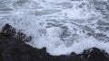 Close-up of surge of waves on rocky shore. Clip. Beautiful waves with splash roll on stones of seashore. Beautiful Royalty Free Stock Photo