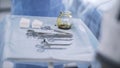 Close up of surgical table with instruments. Action. Medical sterile tools lying on a table with an iodine bowl, concept Royalty Free Stock Photo