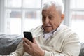 Close up surprised excited mature man looking at phone screen Royalty Free Stock Photo