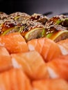 Close up of sushi rolls with avocado slices and California rolls sauce in a blurred foreground. Royalty Free Stock Photo