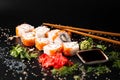 Close up of sushi rolls on black tray