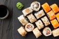 close up of sushi rolls on black tray
