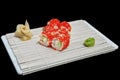 Close-up of sushi and rolls in the restaurant kitchen. Japanese traditional cuisine. California sushi rolls on bamboo backing Royalty Free Stock Photo