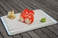 Close-up of sushi and rolls in the restaurant kitchen. Japanese traditional cuisine. California sushi rolls on bamboo backing on Royalty Free Stock Photo