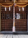 Close-up of Suzu Japanese Shinto bell and the rope hanging under the eaves