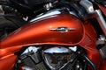 Close-up, Suzuki Boulevard, fuel tank. logo, badge on the glossy red body of motorcycle. Stylish photo details of motorbike. chrom