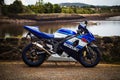 Close-up of a Suzuki motorcycle parked against a backdrop of mountains in Conwy, Wales