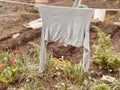 Close up of sweater drying on rope in kitchen garden. Grey clothes drying outdoors in countryside.