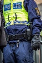 Close up of Swedish police officer wearing a luminous yellow green vest with police text. Royalty Free Stock Photo