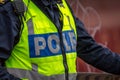 Close up of Swedish police officer wearing a luminous yellow green vest. Royalty Free Stock Photo