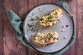 Close up of swedish salad with anchovies, potatoes and egg on rye bread on a plate top view Royalty Free Stock Photo