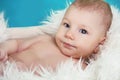 Close-up of sweet little baby boy face, looking up, over blue ba Royalty Free Stock Photo