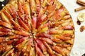Close up Sweet traditional homemade german apple pie cake with nuts and cinnamon on dark wooden table