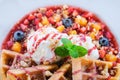 Close up of Sweet waffles with strawberries sauce vanilla ice cream and fresh fruit Royalty Free Stock Photo