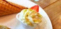 Close up sweet whipped cream with green tea powder on topping and fresh strawberry serve with baked ice cream cone on white plate Royalty Free Stock Photo