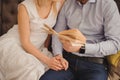 Close up Sweet Young Couple Sitting at Couch In the Living Room, Reading a Book Together Royalty Free Stock Photo