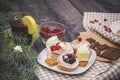 Close-up of sweets on a white plate: coconut biscuit, pastila, meringue, cream roses, Turkish delight, next to a broken chocolate