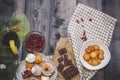 Close-up of sweets on a white plate: coconut biscuit, pastila, meringue, cream roses, Turkish delight, next to a broken chocolate