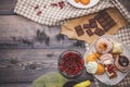 Close-up of sweets on a white plate: coconut pechente, pastila, meringue, cream roses, razat Turkish delight, near a broken
